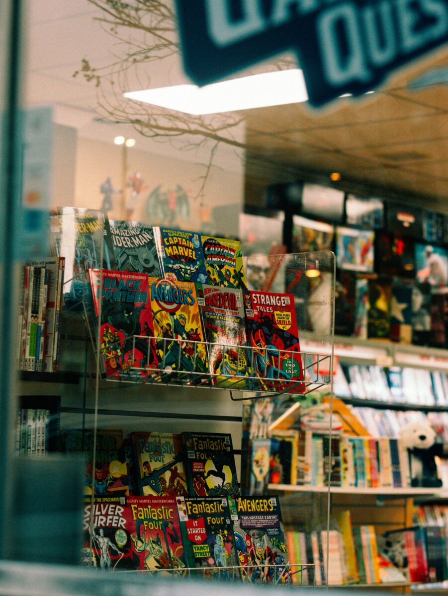 Colorful comic books displayed in a store window in Atlanta, GA, USA.